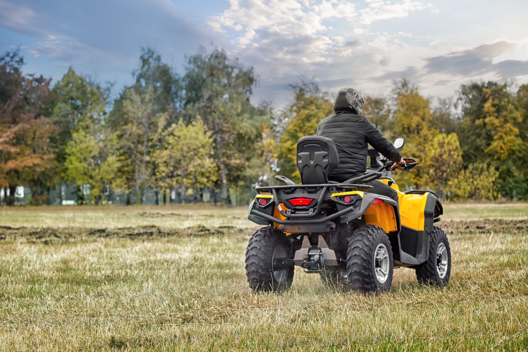 racer-on-yellow-atv-leaving-into-the-distance.jpg